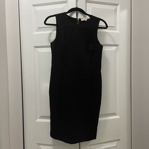 Black form fitting work dress with exposed zipper